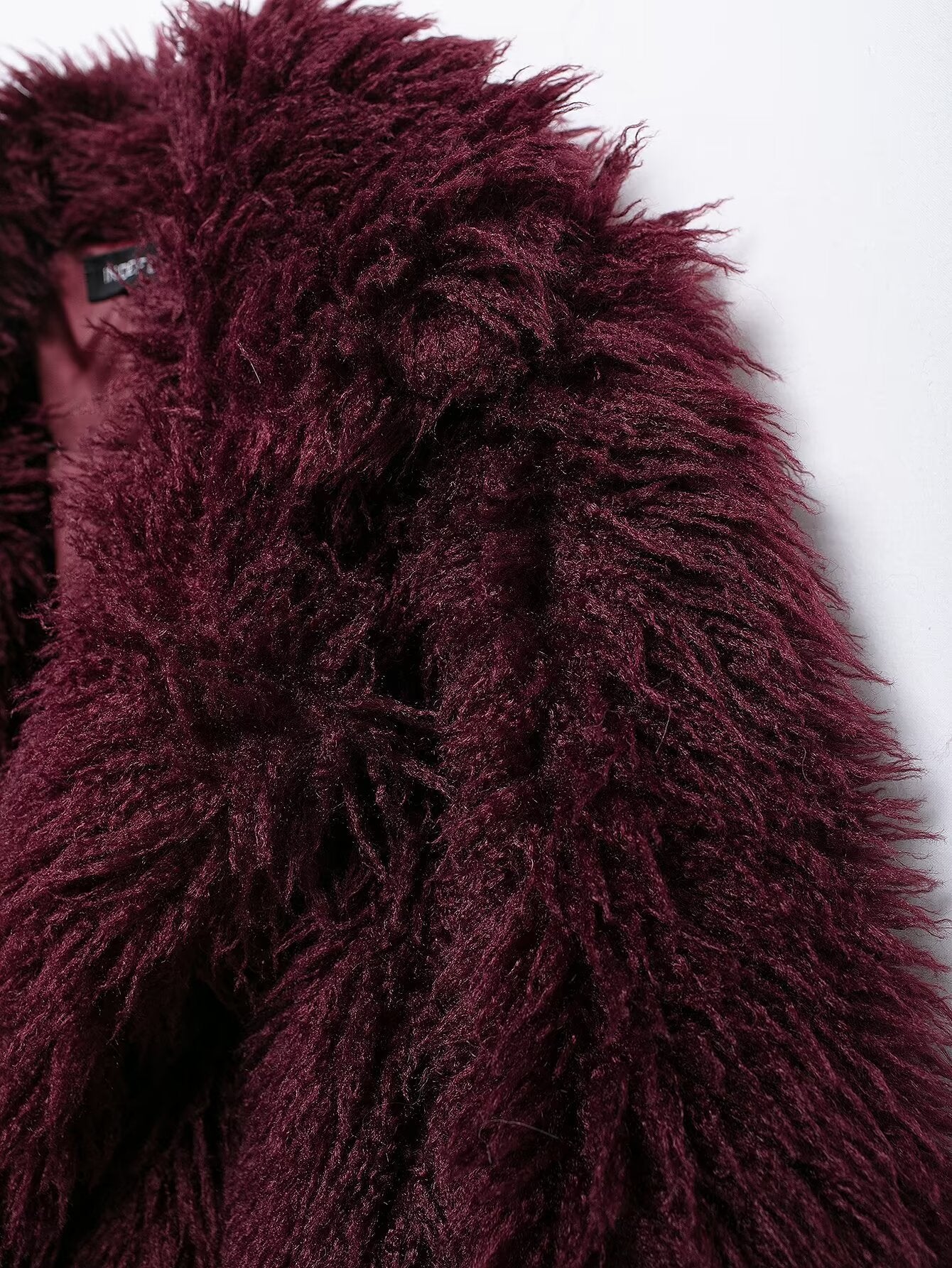 Burgundy faux fur coat showcasing luxurious faux fur fashion and elegant style
