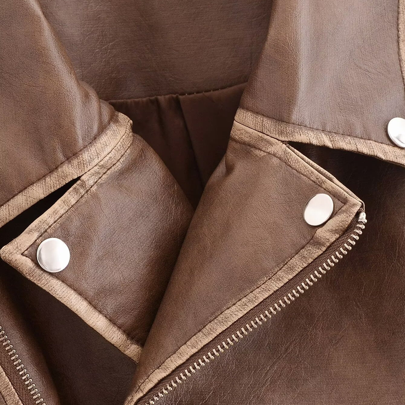 Winter Street faux leather motorcycle jacket in brown with white buttons and zipper details