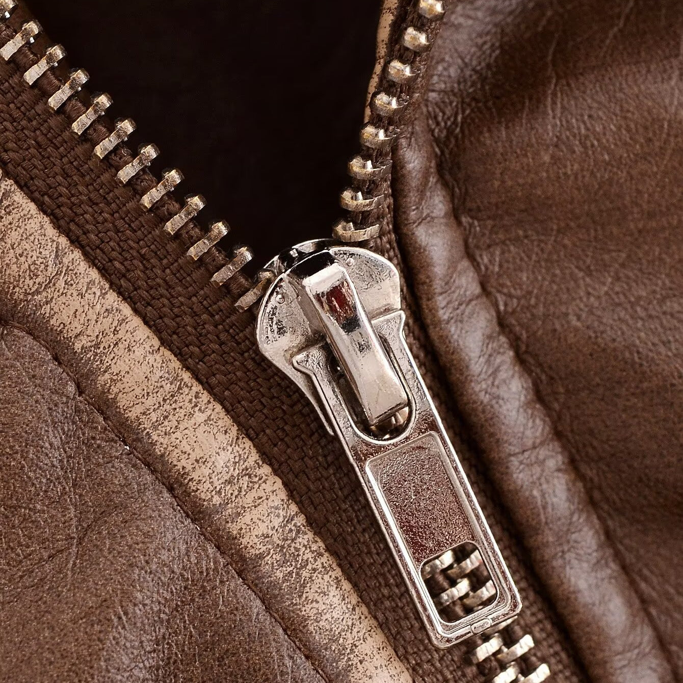 Faux leather motorcycle jacket zipper with silver teeth and metal slider