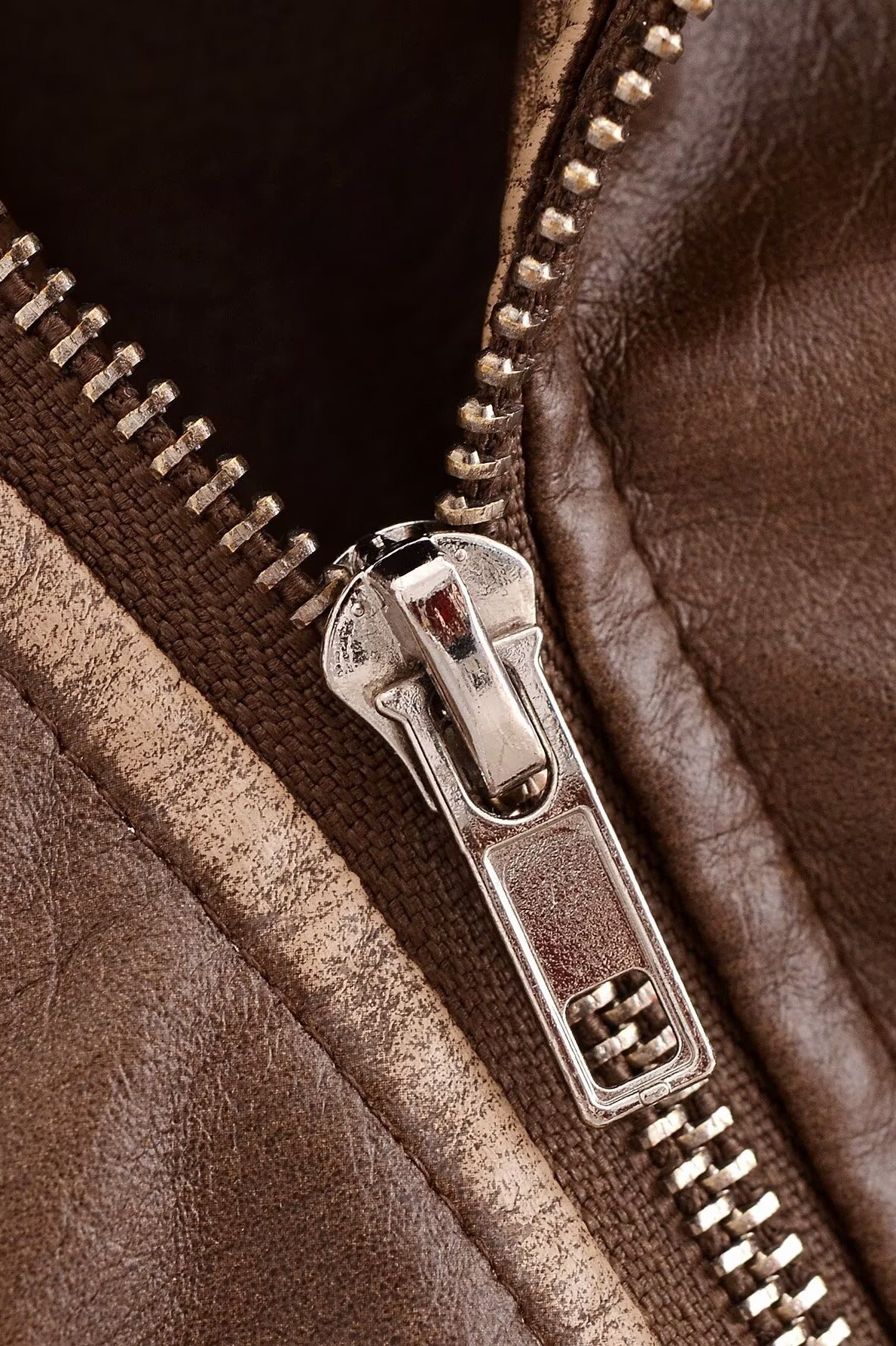 Faux leather motorcycle jacket zipper with silver teeth and metal slider