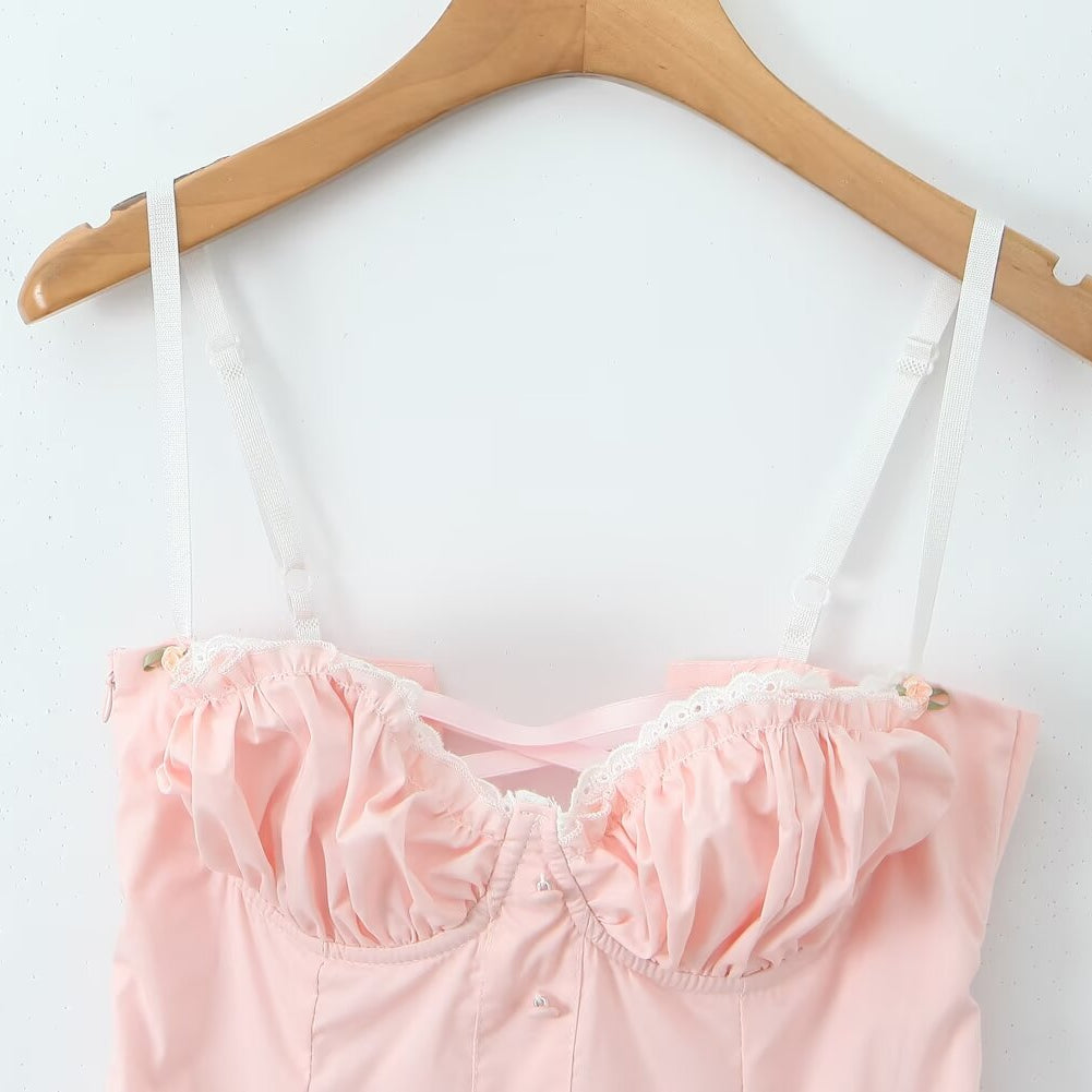 Pink bustier top with white straps on wooden hanger, part of Enchanting Steel Bracket Short Dress