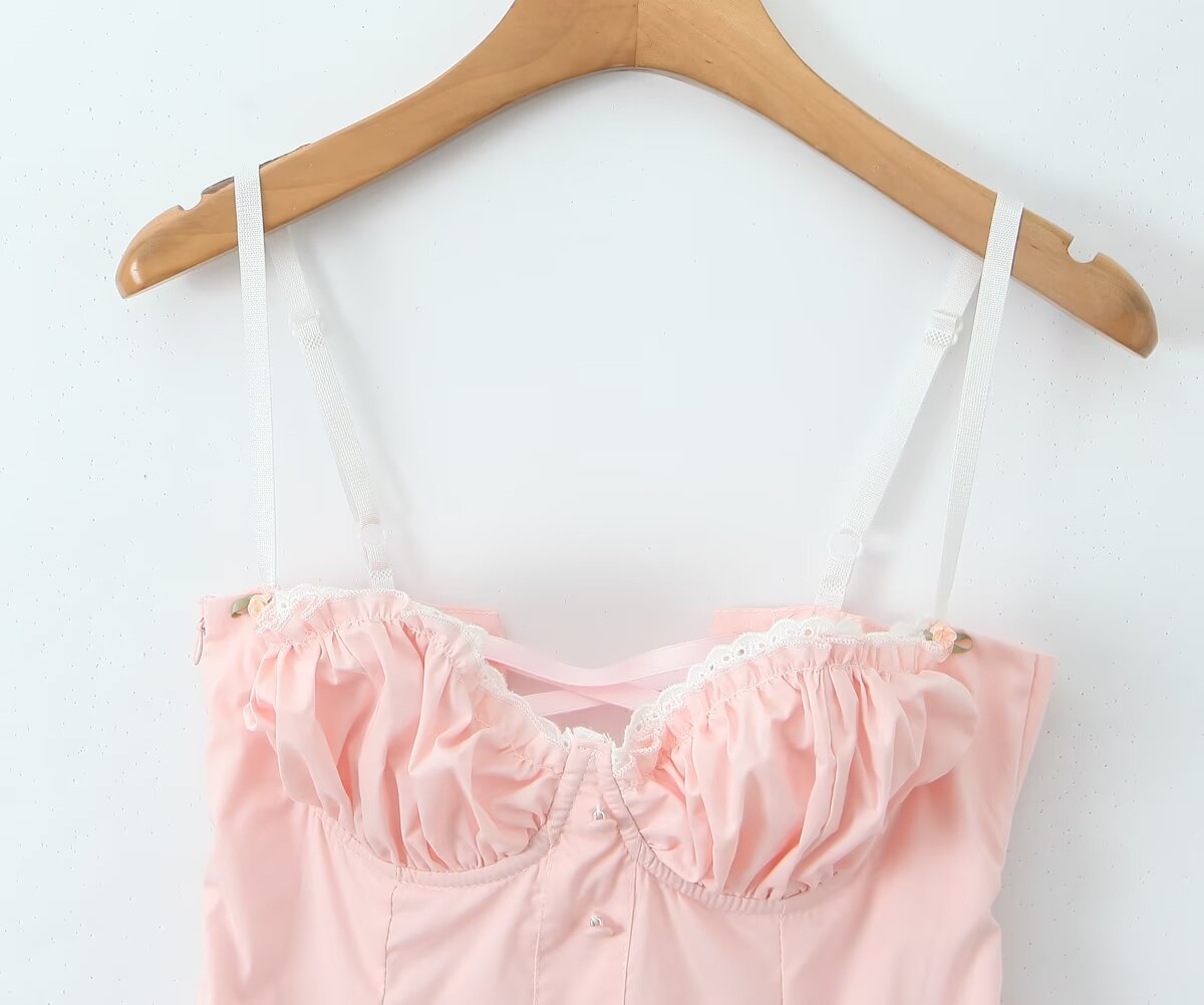 Pink bustier top with white straps on wooden hanger, part of Enchanting Steel Bracket Short Dress