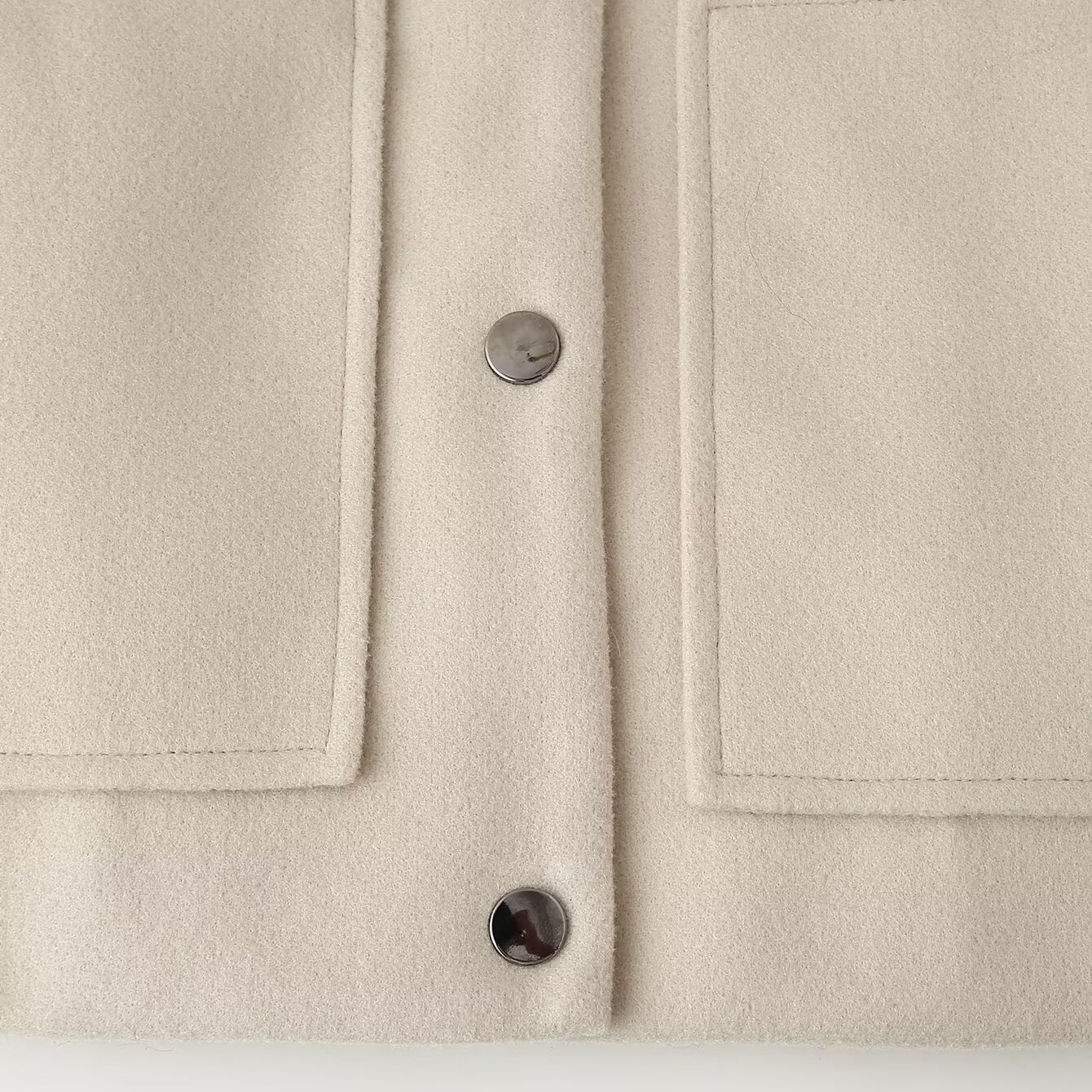 Cream-colored minimalist single breasted Langry fashion jacket coat with pocket details