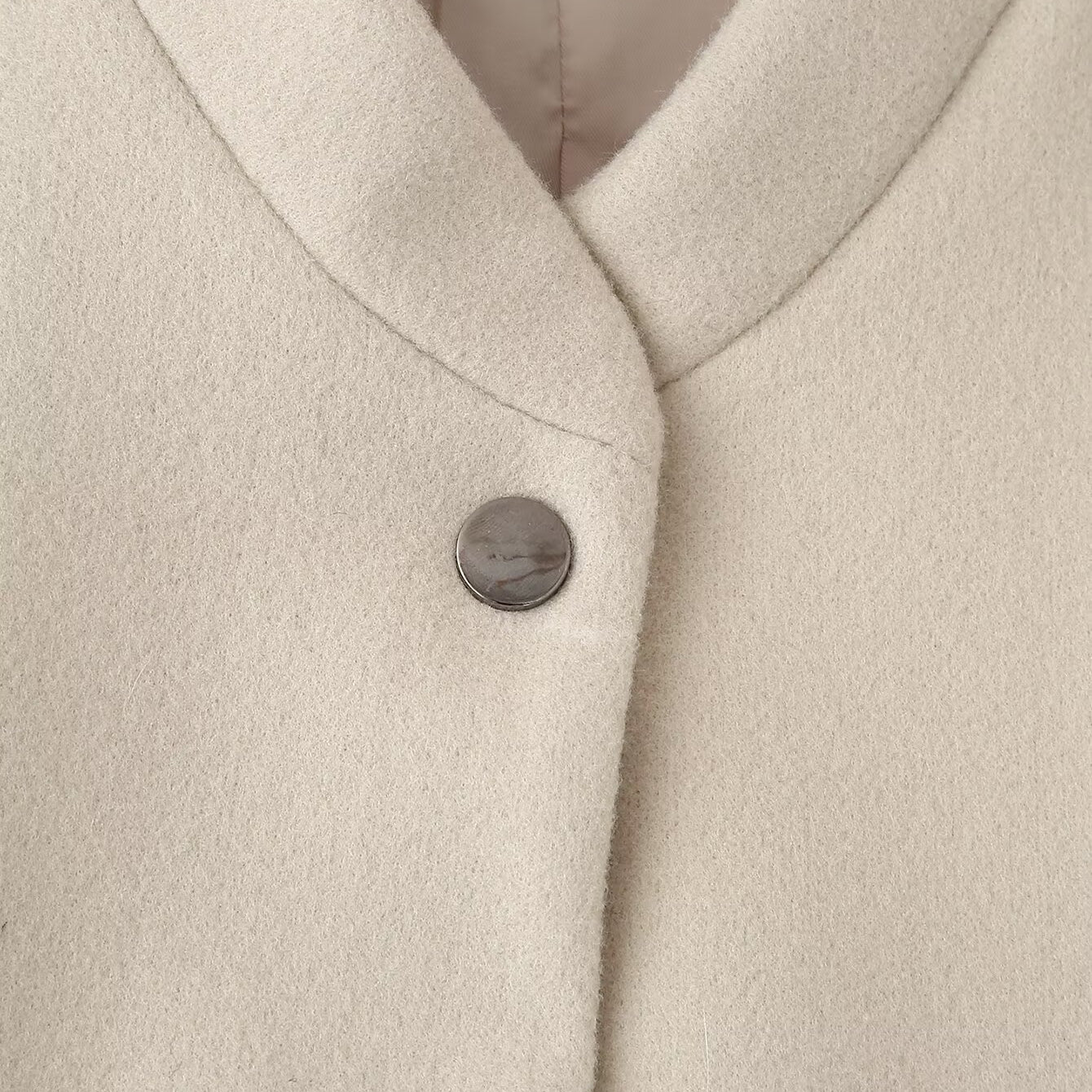 Cream-colored single breasted wool coat with silver buttons