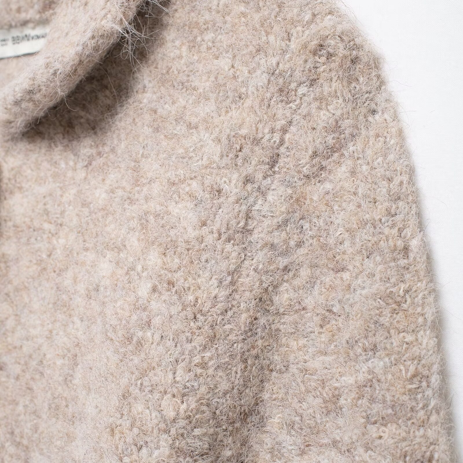 Elegant Langry beige boucle sweater with floral button knit design