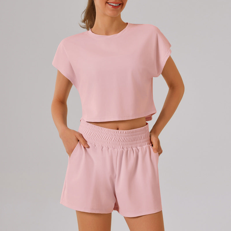Pink crop top and shorts loungewear set from the Loose Sports Yoga Fitness Set, fashionable ملابس