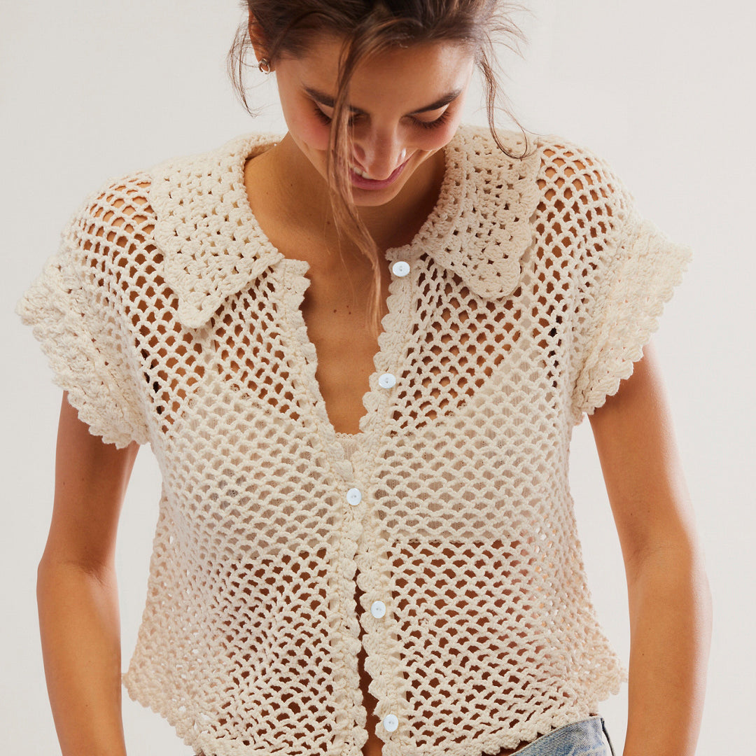 Cream-colored crochet button-up top styled with blue jeans for fashionable langry ملابس