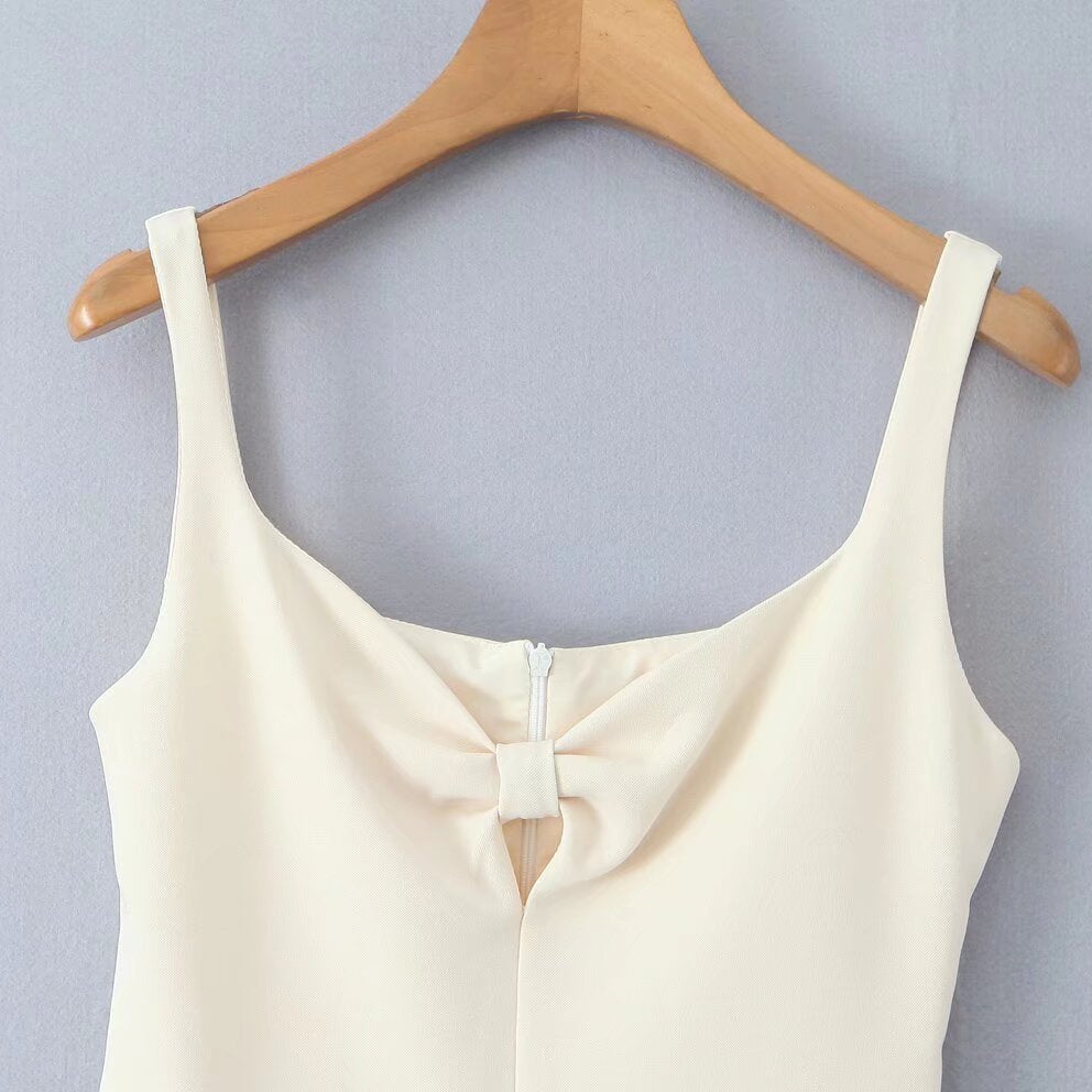 White sleeveless top with bow detail, enhancing the fashion of the Stunning Retro Backless Dress