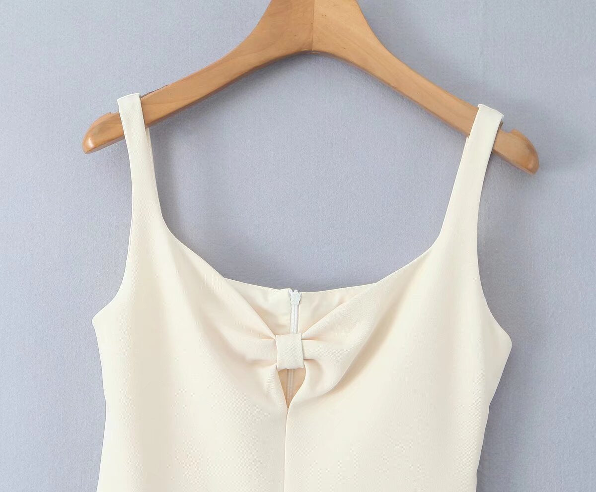 White sleeveless top with bow detail, enhancing the fashion of the Stunning Retro Backless Dress