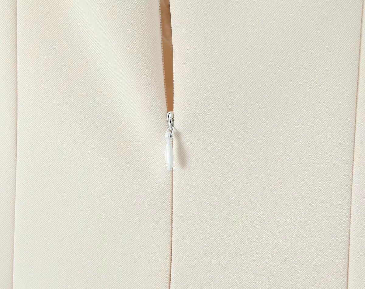 White zipper on a seam of the Stunning Retro Backless Dress, a stylish fashion choice