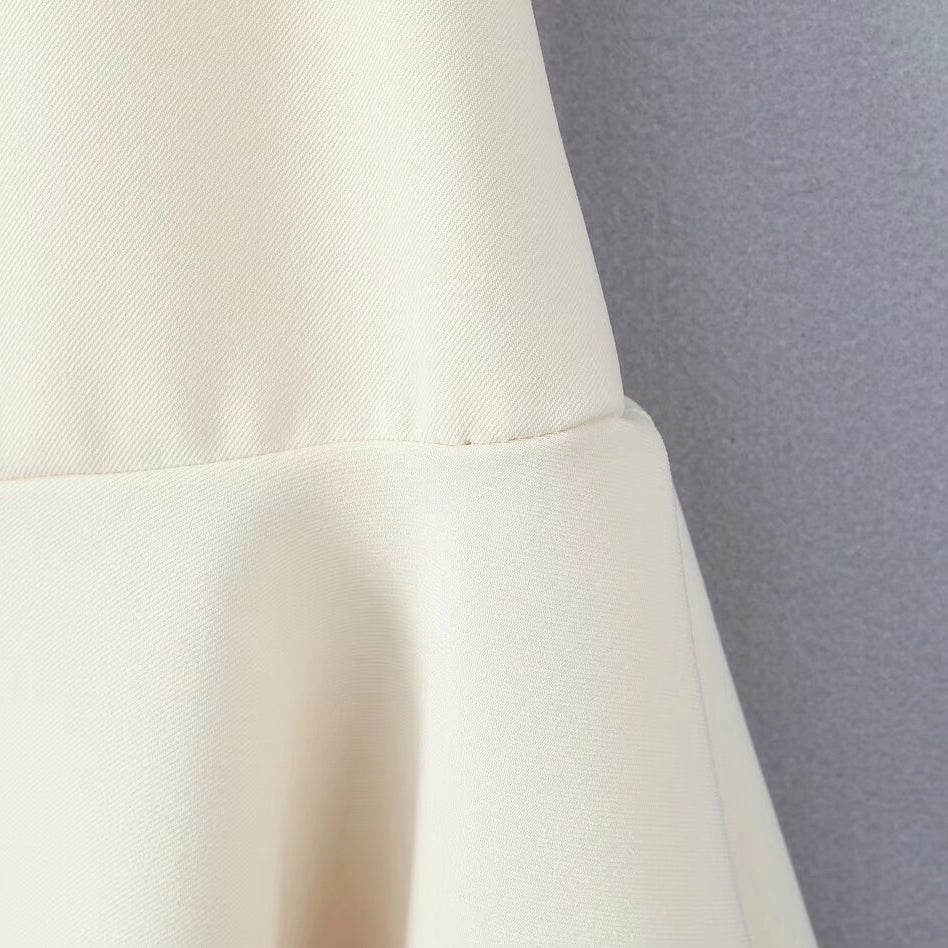 White fabric with seam detail showcasing the Stunning Retro Backless Dress in fashion