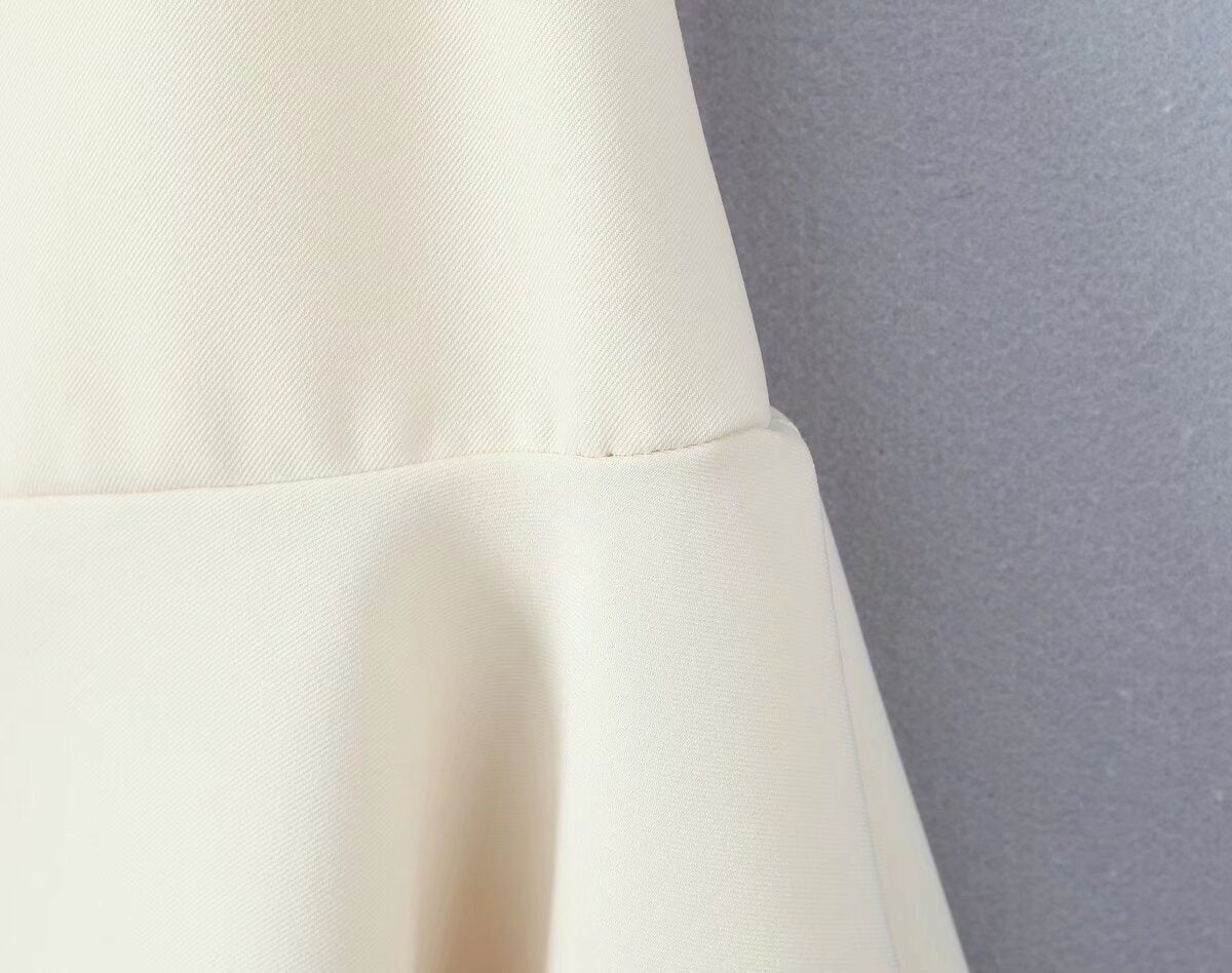 White fabric with seam detail showcasing the Stunning Retro Backless Dress in fashion