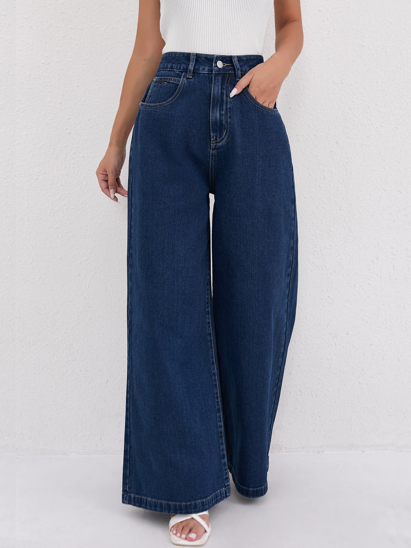 Dark blue wide leg mopping jeans featuring traditional five-pocket styling