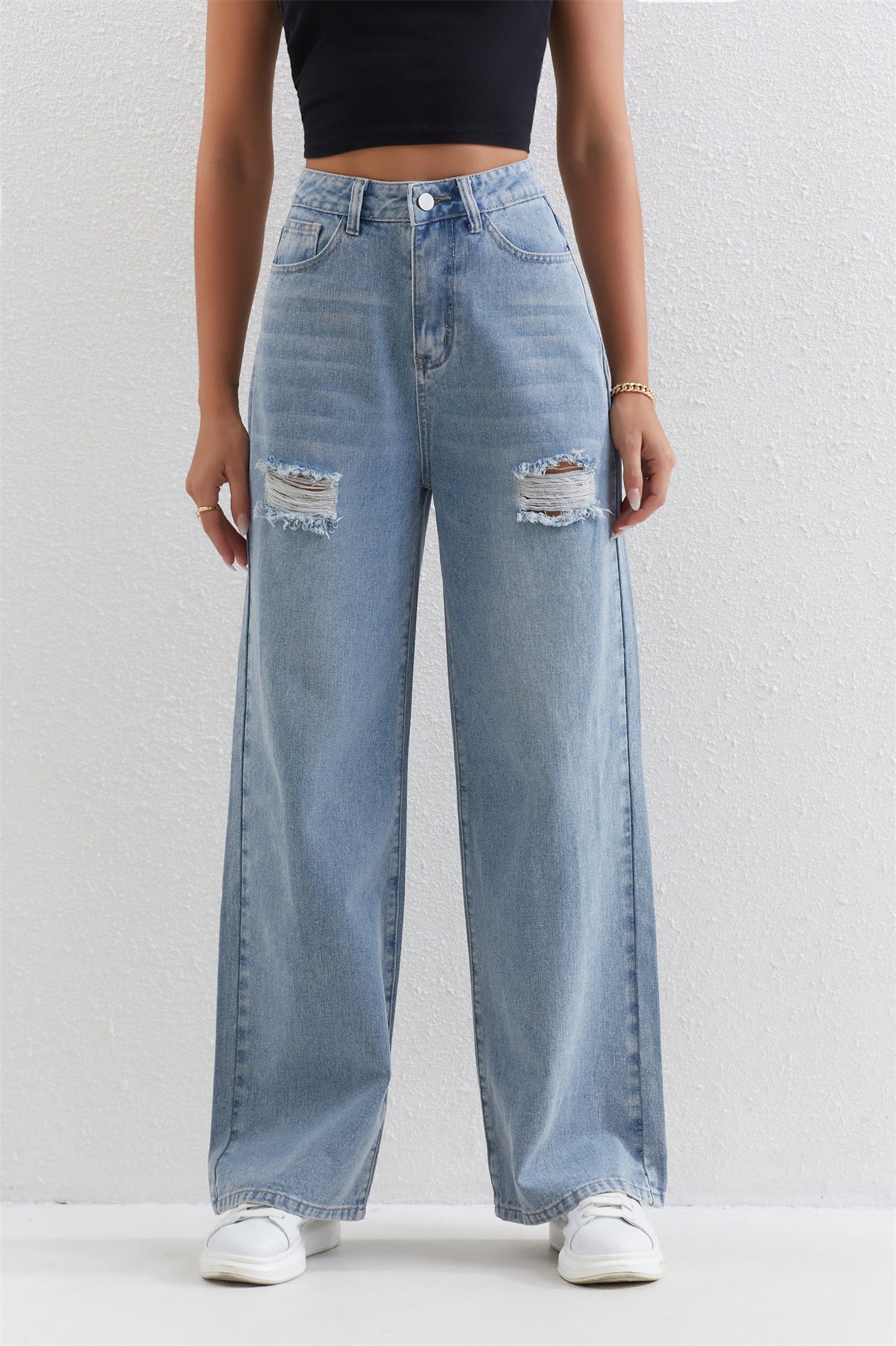 Light blue distressed wide-leg jeans with ripped knees for stylish and comfortable fashion