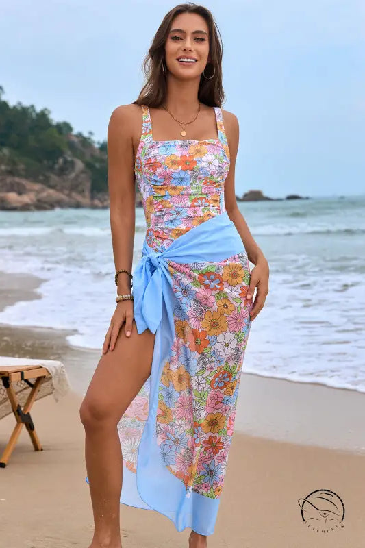 Floral one piece swimsuit with light blue sarong wrap in orange pink tropical print