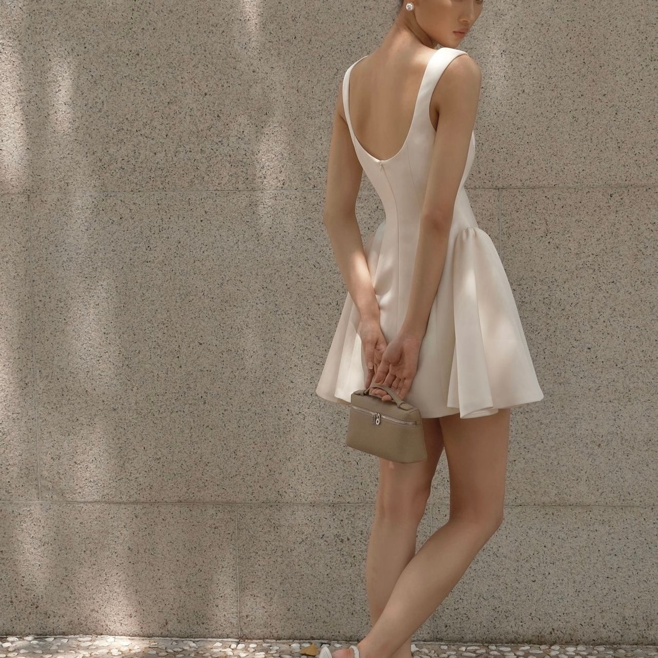 Woman in a white dress and handbag showcasing Beautiful Tight Waist a Swing Sling Dress fashion