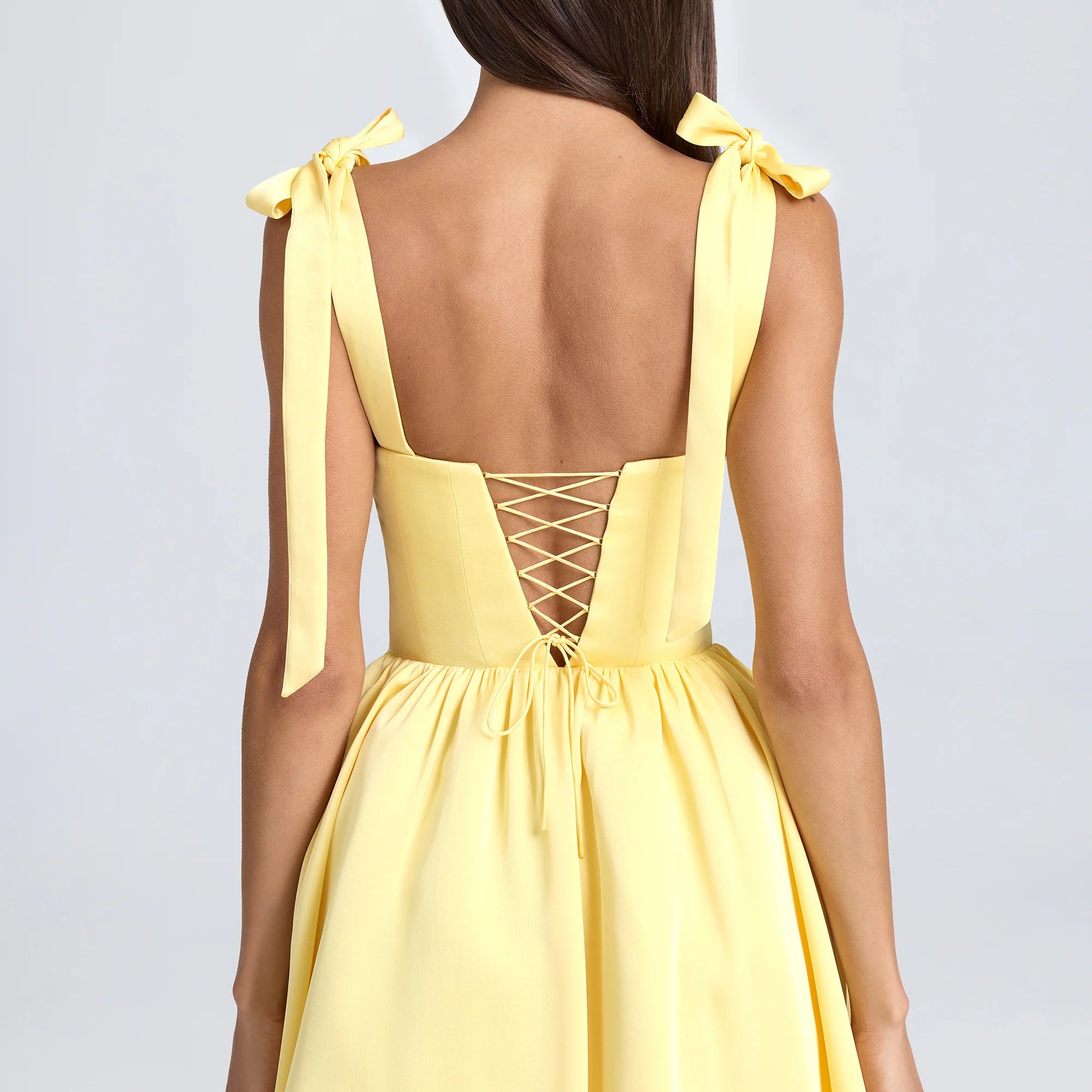 Yellow mini dress with tie straps and corset back, perfect for trendy langry fashion