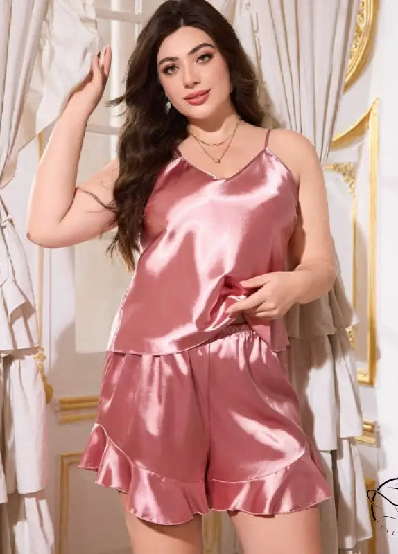 Pink satin langry pajama set with ruffled hem and spaghetti straps