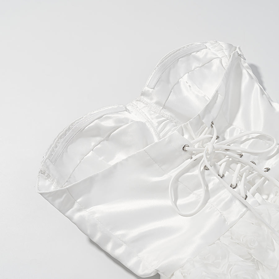 White satin lace-up shoe with silver accents, bow, and early spring floral design