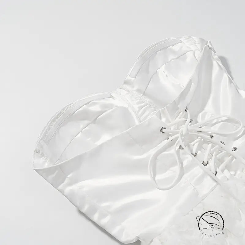 White satin lace-up shoe with silver accents, bow, and early spring floral design