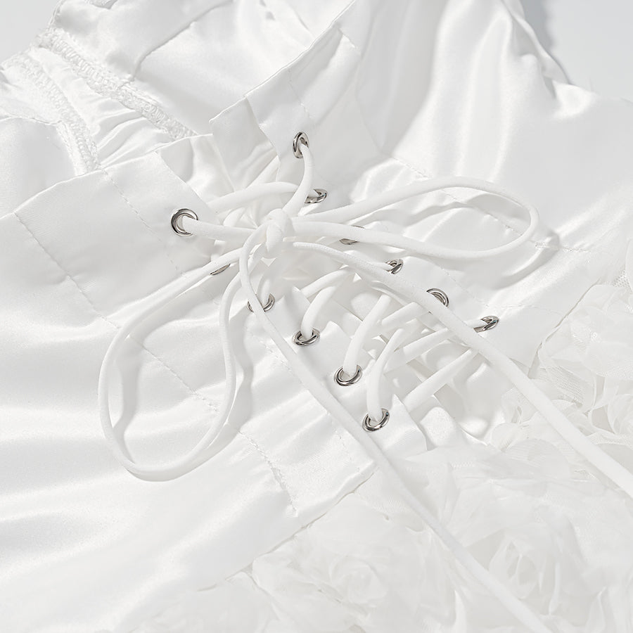 White lace-up boot with silver eyelets on early spring floral dress