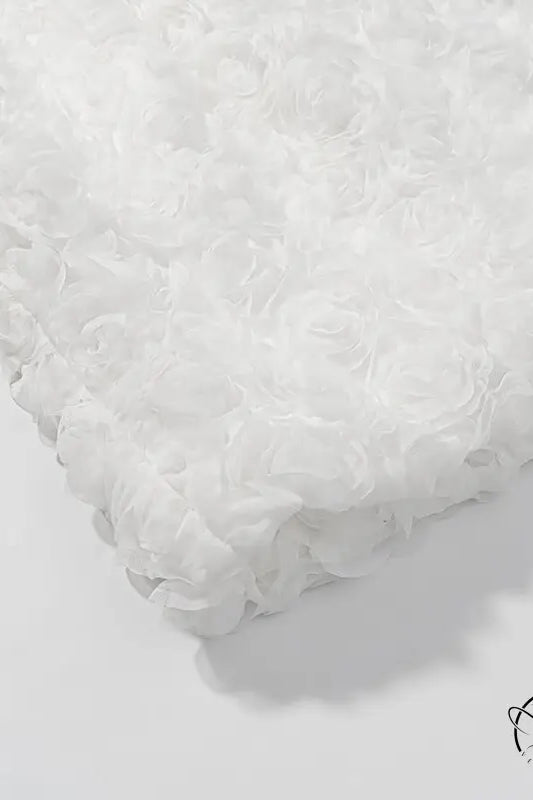 White fluffy bath mat with early spring floral three dimensional texture