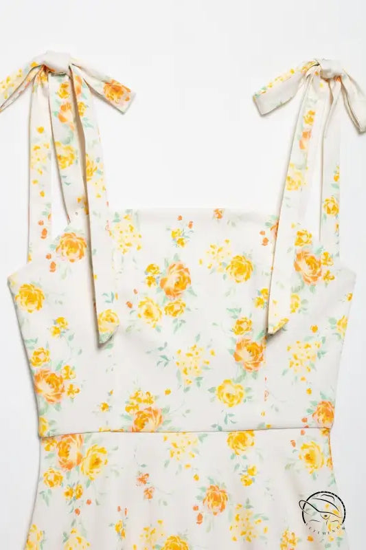 White floral print poplin dress with yellow roses, green leaves, tied straps
