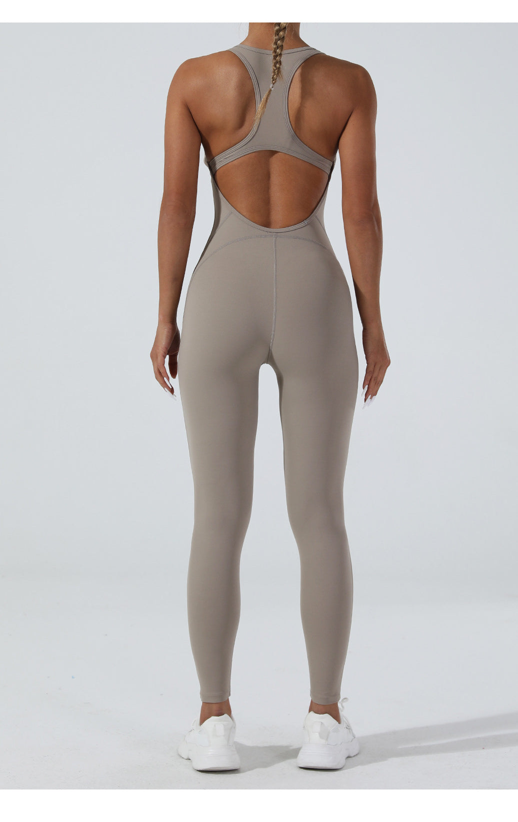 Sleek taupe langry yoga one-piece jumpsuit with racerback and open back