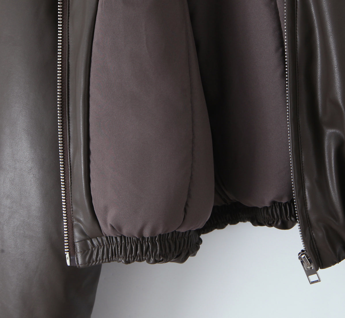 Loose faux leather bomber jacket by Langry with silver zipper and elastic hem