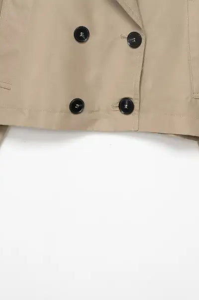 Beige double breasted short trench coat with black buttons and pockets