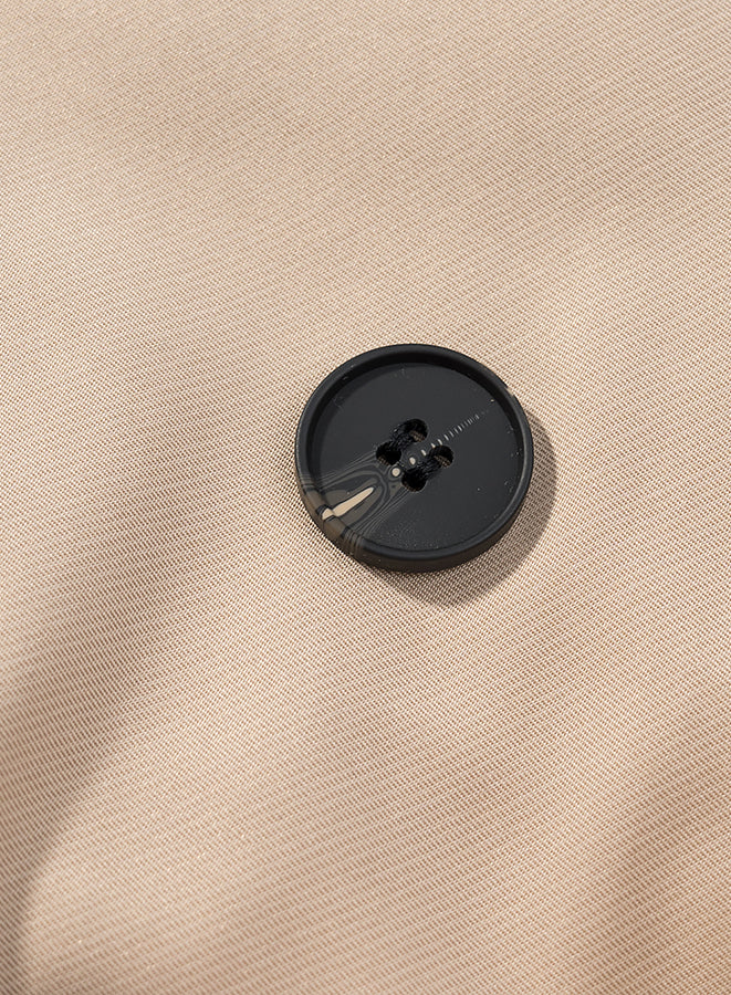 Casual long sleeve belt short trench coat with black button on beige fabric