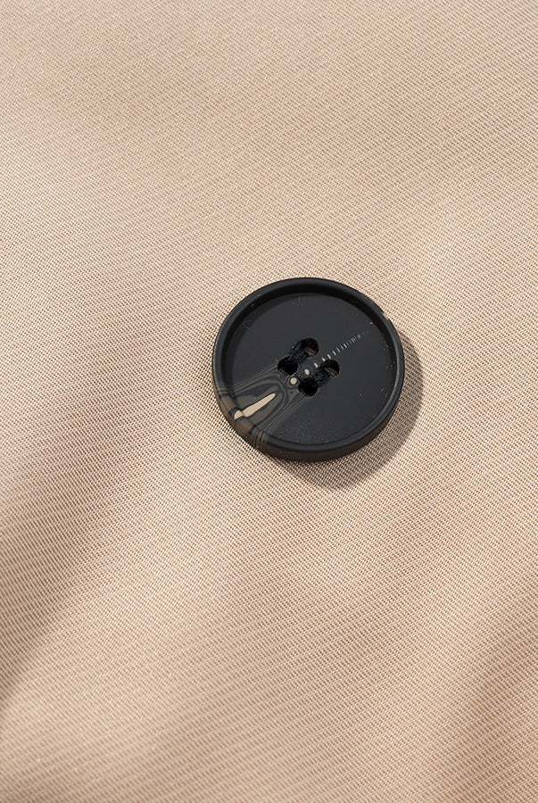 Casual long sleeve belt short trench coat with black button on beige fabric