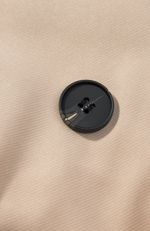 Casual long sleeve belt short trench coat with black button on beige fabric