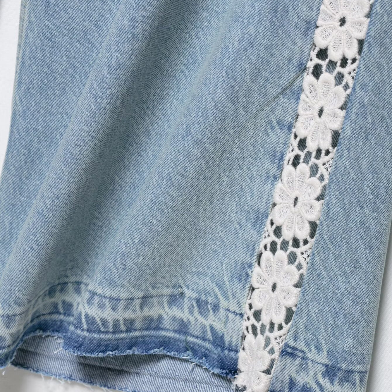 High waist wide leg denim shorts with white lace trim and frayed edges