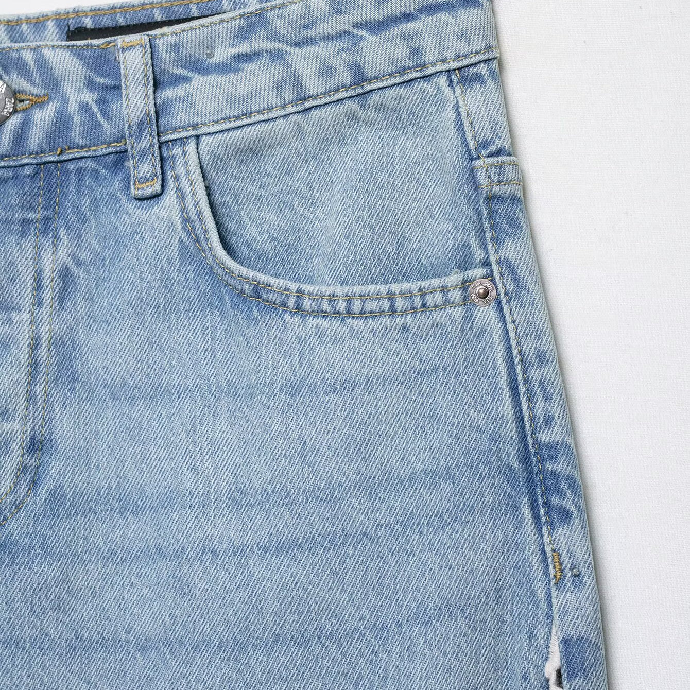 Light blue wide leg denim jeans with crochet stitching and distressed details