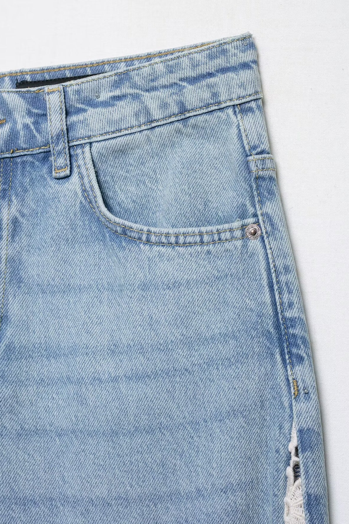 Light blue wide leg denim jeans with crochet stitching and distressed details