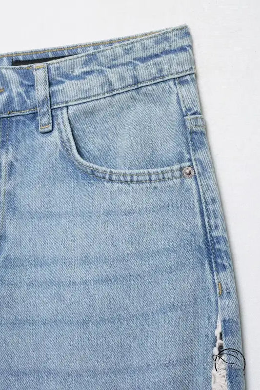 High waist wide leg jeans with light blue denim, distressed details, button fly, and spring autumn crochet stitching