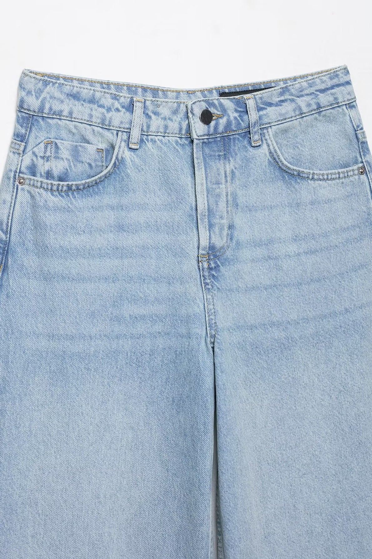 Light blue wide leg denim jeans with distressed patches and crochet stitching