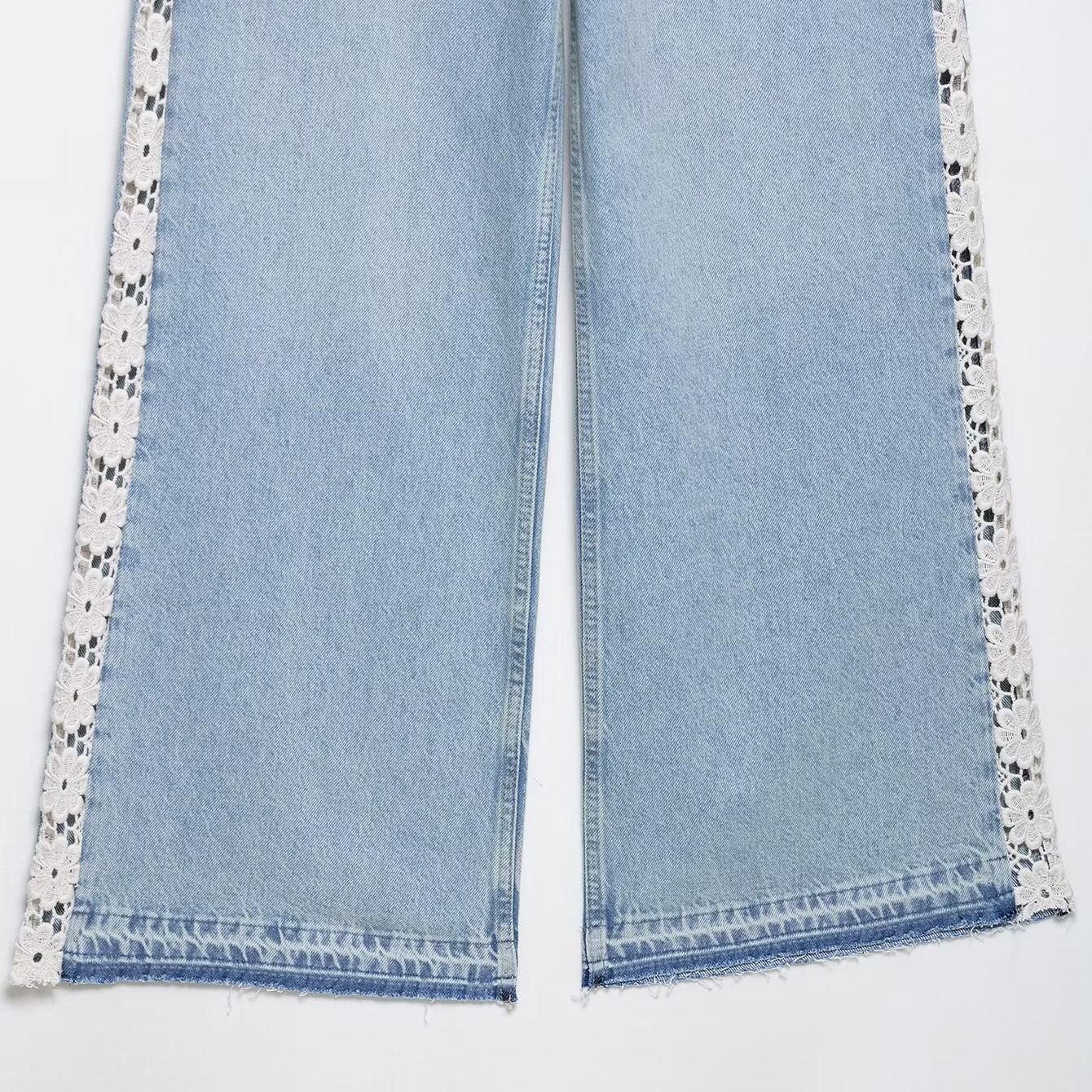 Light blue Zara wide leg jeans with white lace trim and crochet stitching