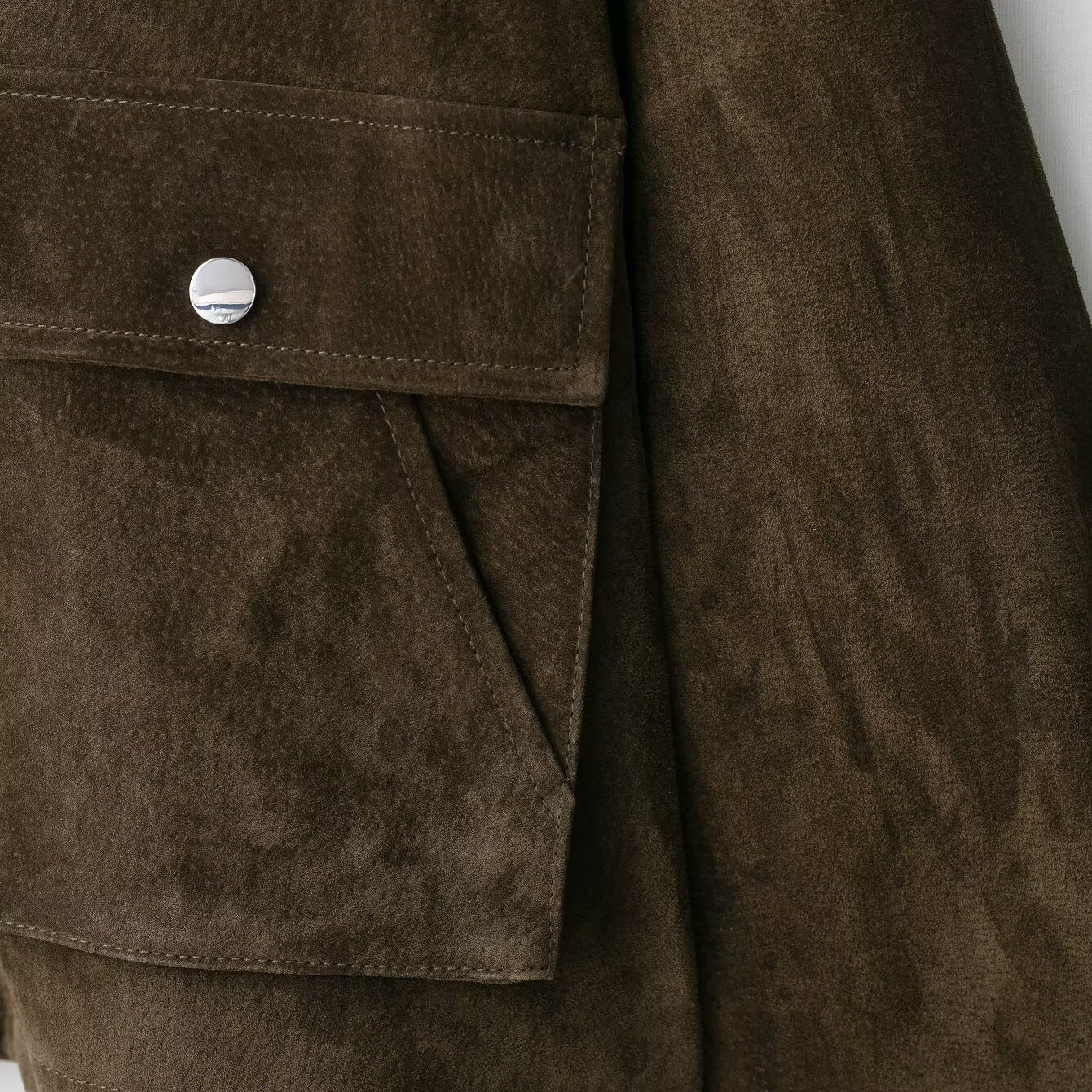 Brown suede leather bomber jacket with button closure and pocket detail