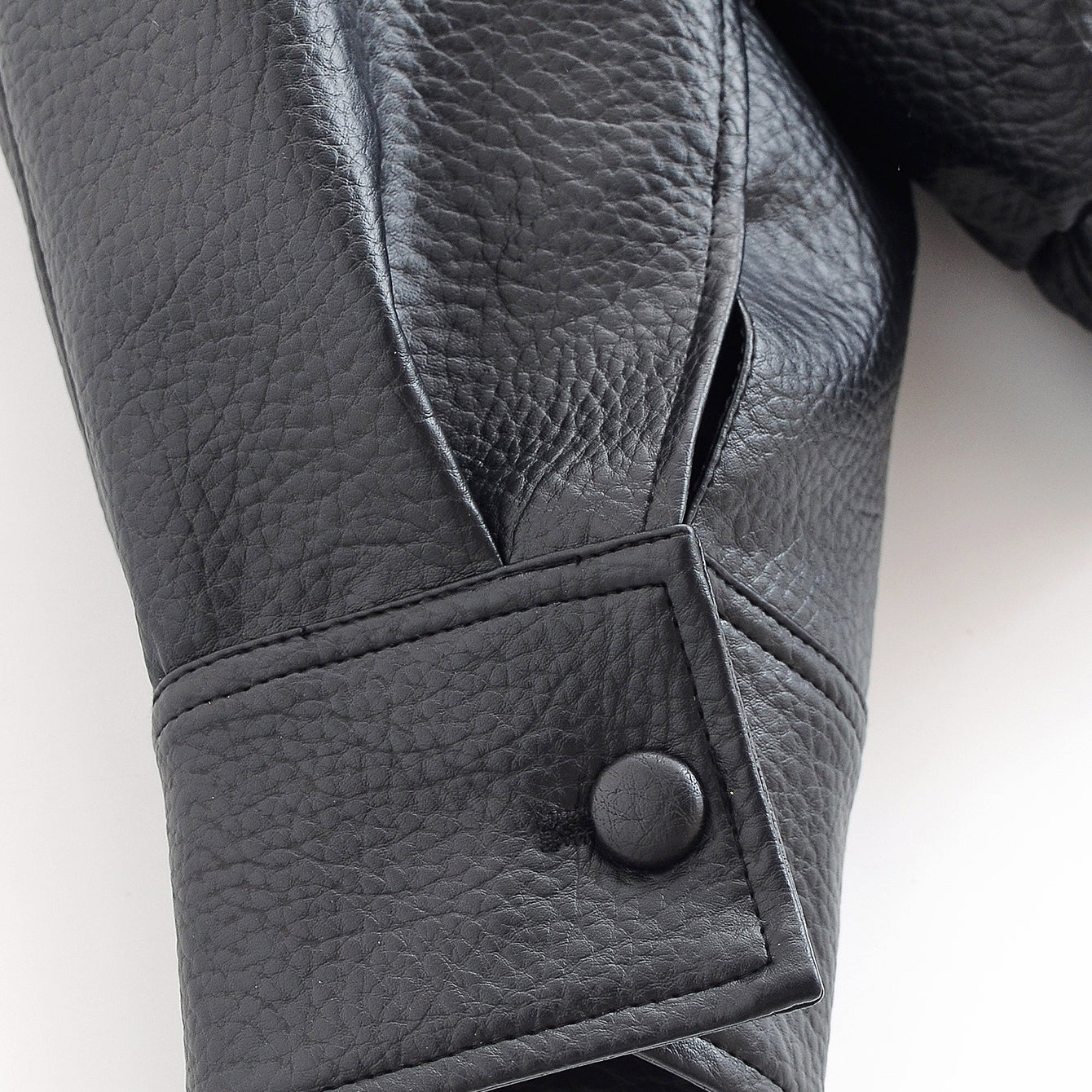 Retro faux leather jacket with buttoned cuffs and textured surface by Langry