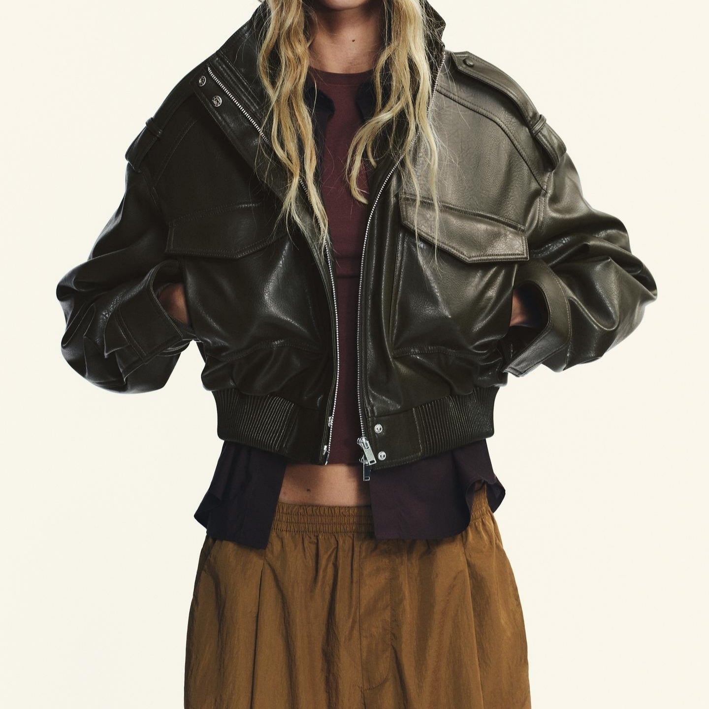 Black faux leather bomber jacket with polo collar and zipper details