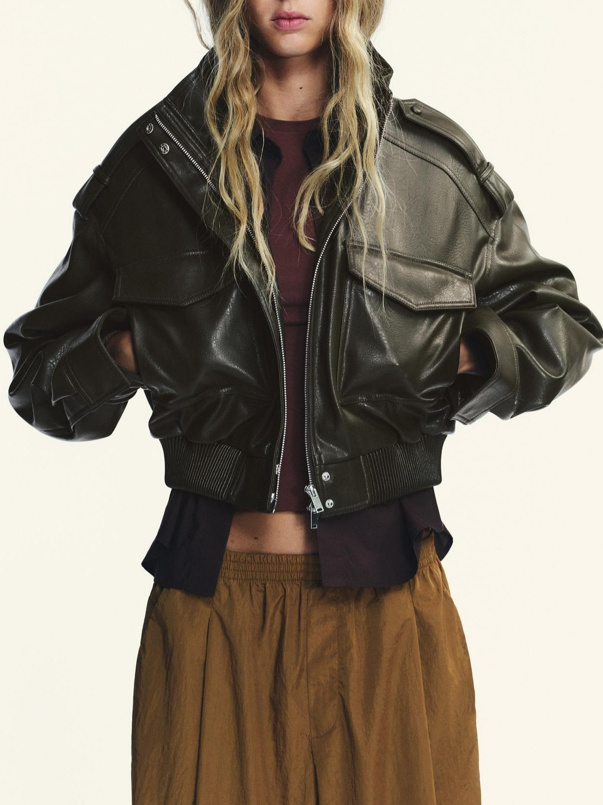 Black faux leather bomber jacket with polo collar and zipper details