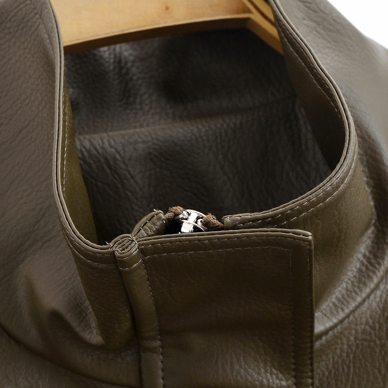Langry faux leather jacket with olive green duffle bag