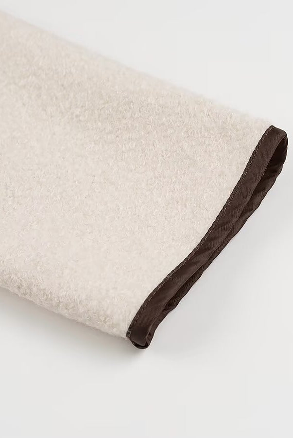 Beige and brown textured towel with dark trim in Langry cozy fashion coat