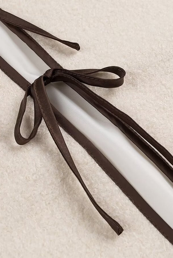 Brown leather shoelaces with bow tie design on Langry fashion coat