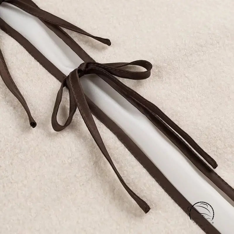 Brown leather shoelaces with bow tie design in cozy lace up coat