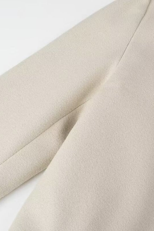 Cream-colored langry fashion trench coat fabric with subtle texture