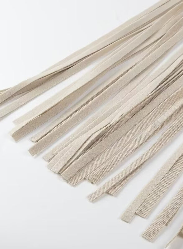 Beige woven cord tassel necklace with silver accents on Langry fashion trench coat