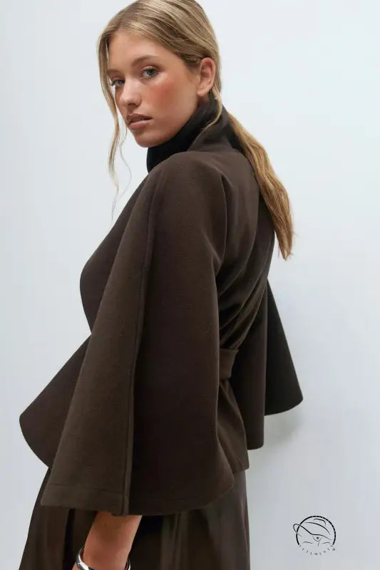 Brown woolen cape coat with black turtleneck and layered skirt by Zara